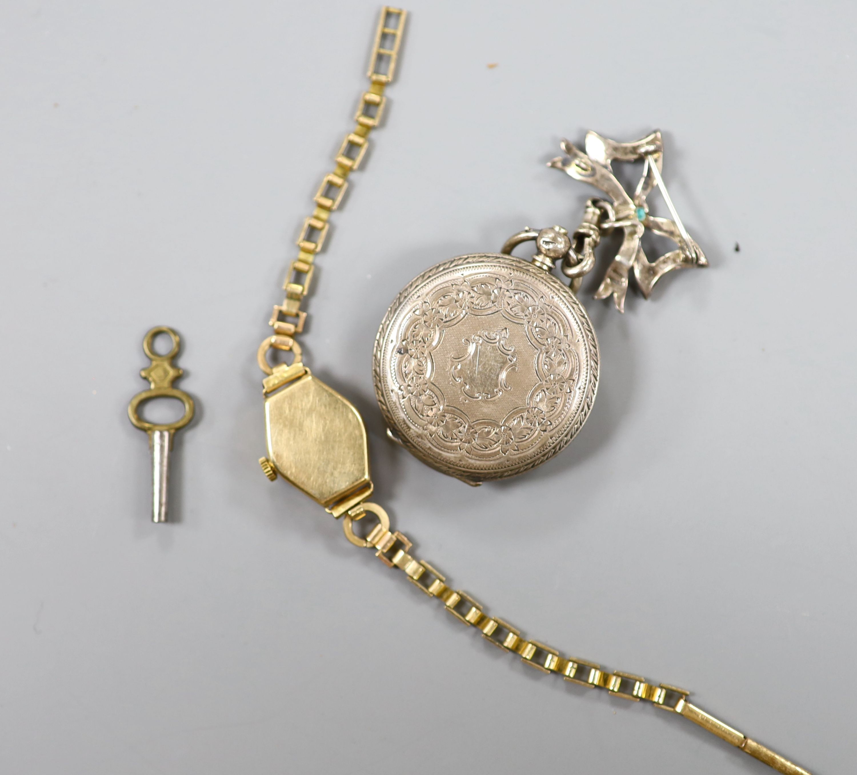 A lady's yellow metal manual wind wrist watch, on a gold plated bracelet, together with a silver fob watch.